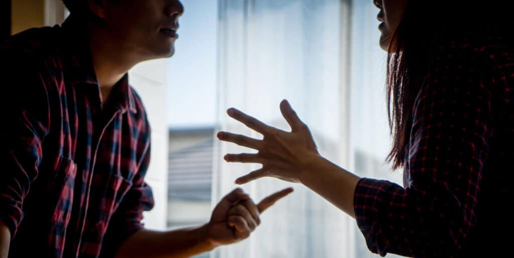 A boyfriend threatening his girlfriend during an argument